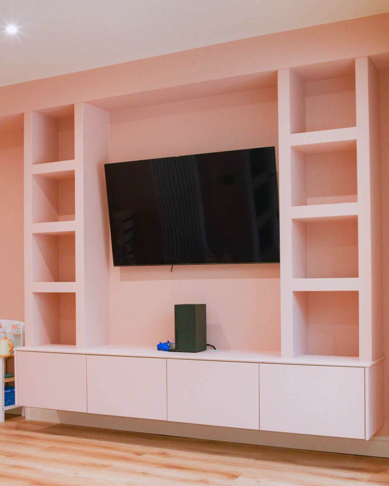 Built-in media wall with TV by JWA Building Services