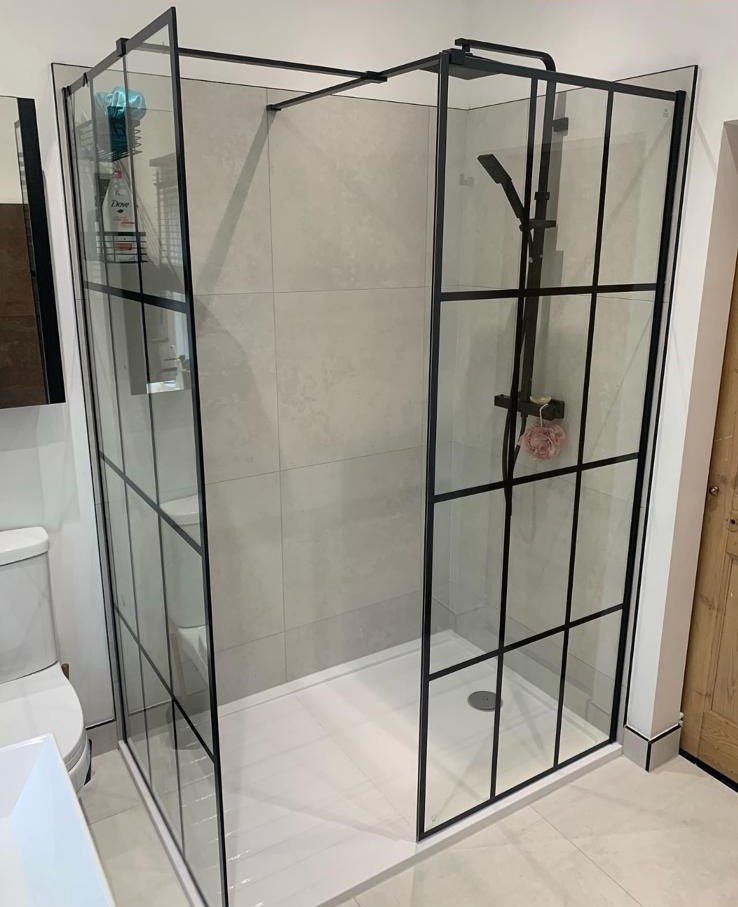 Walk-in shower with black crittall-style screen by JWA Building Services