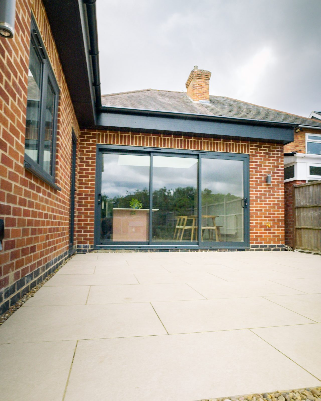 Brick extension with porcelain patio by JWA Building Services