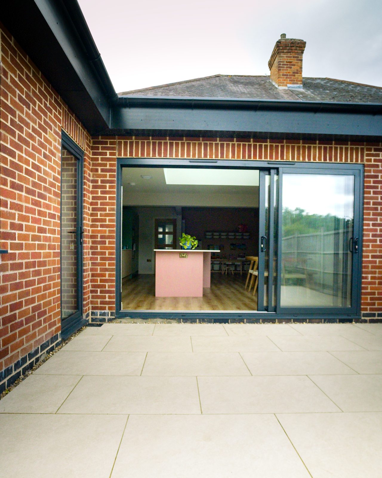 Bi-fold doors opening to the kitchen by JWA Building Services