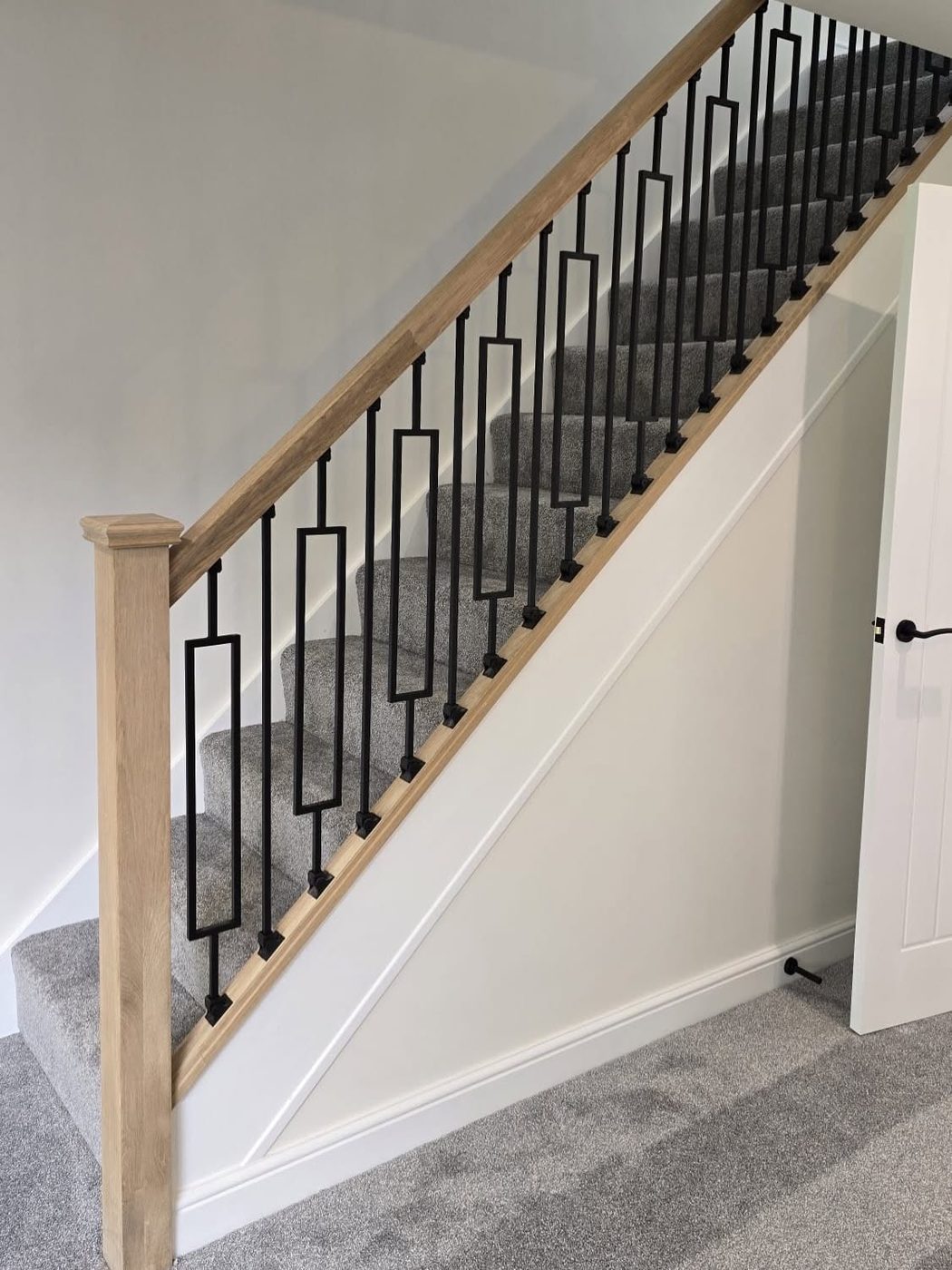 Oak staircase with steel spindles by JWA Building Services