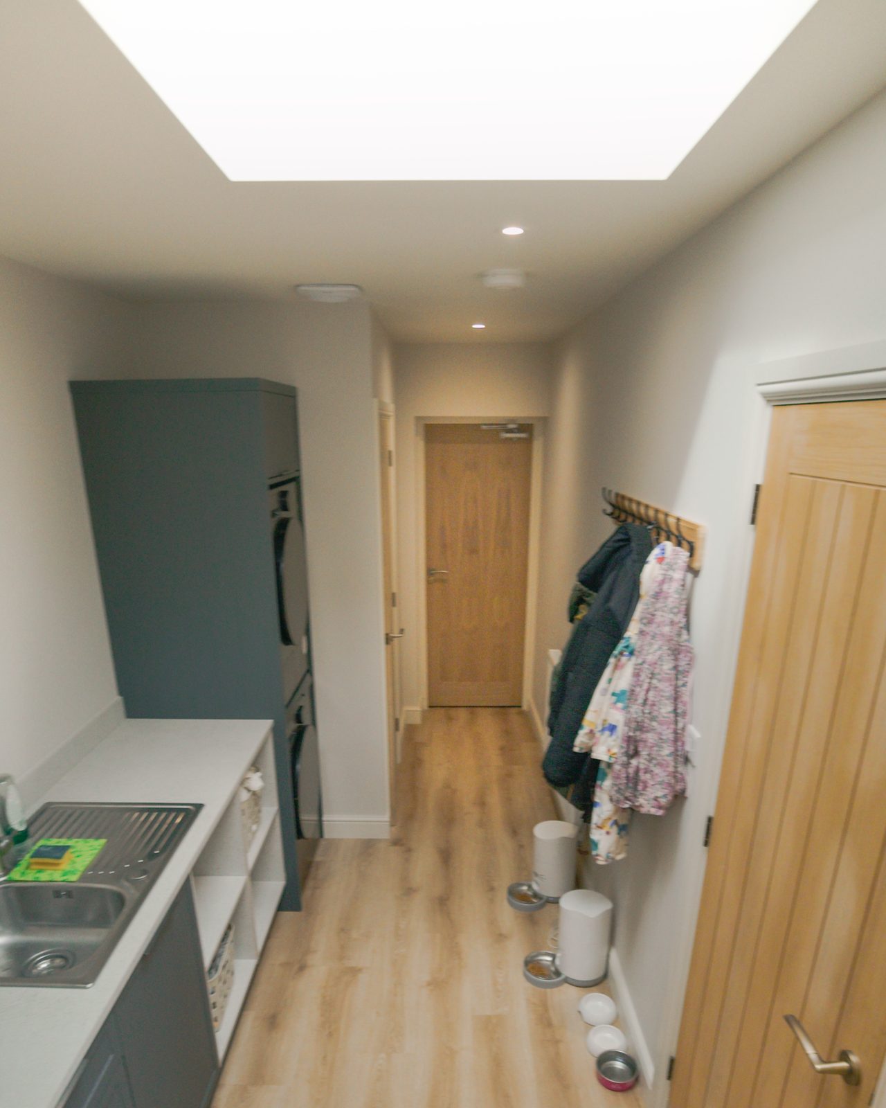 Utility room with green cabinetry by JWA Building Services