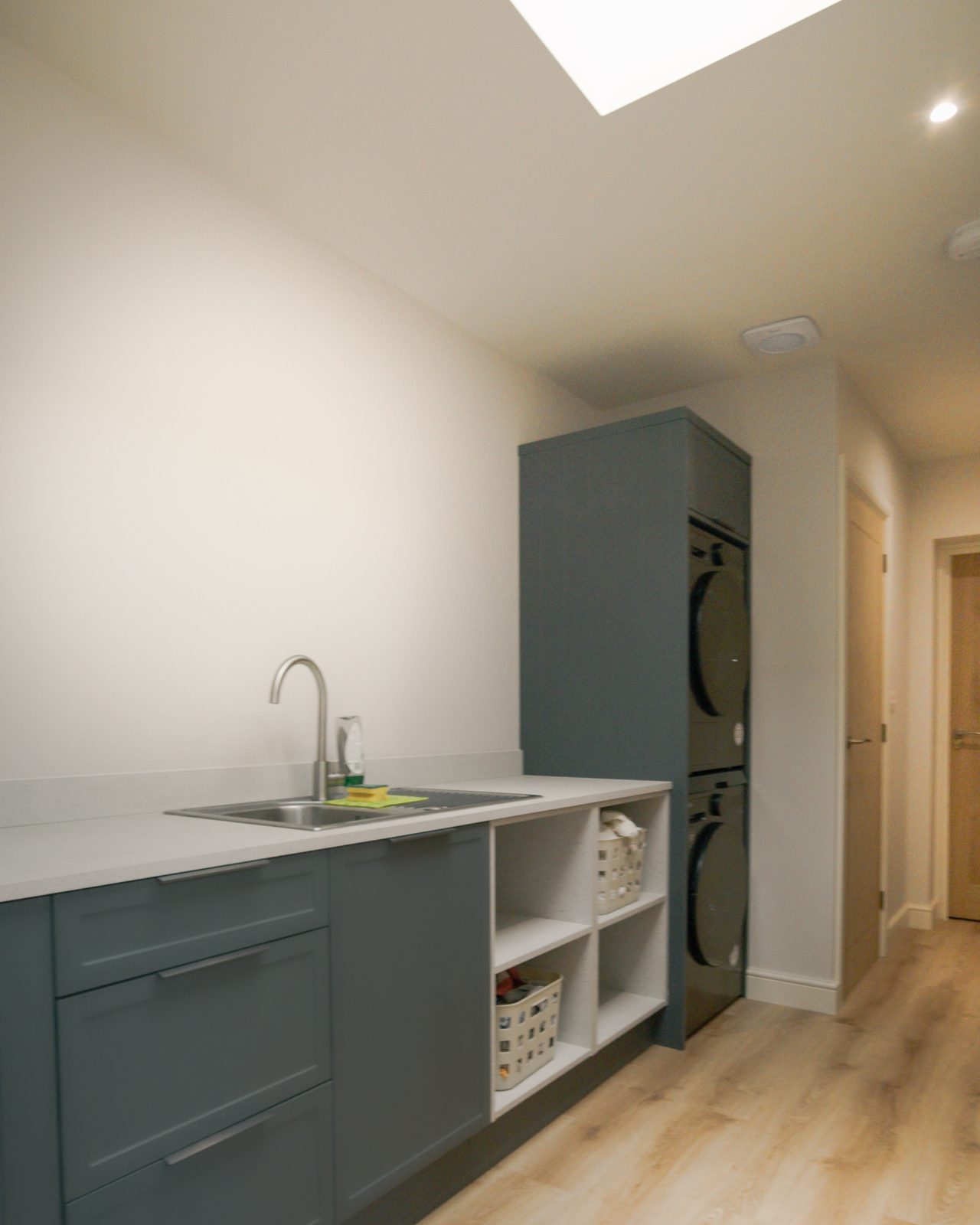 Utility room with integrated appliances by JWA Building Services